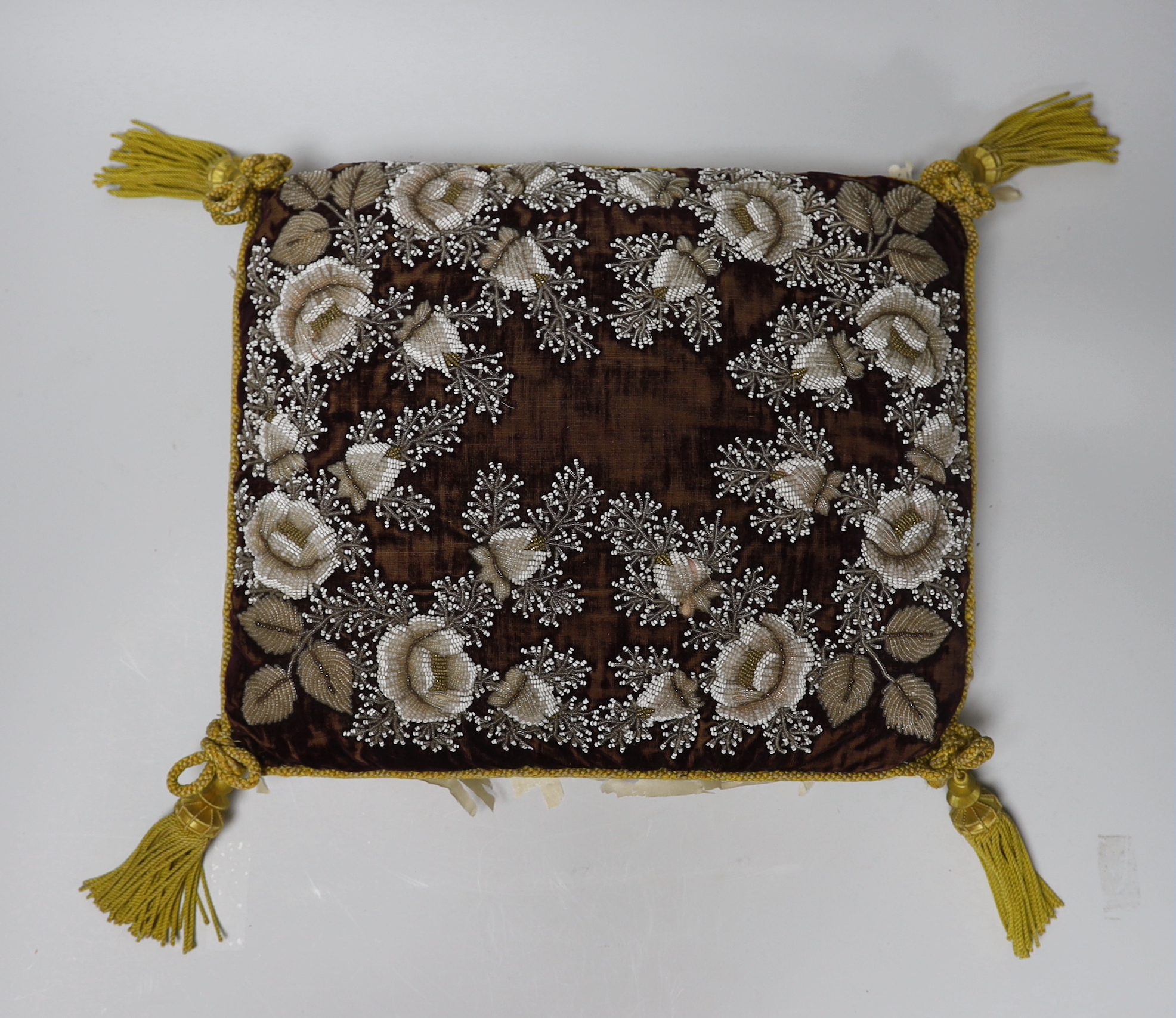 A Berlin-type late 19th century cushion and tea cosy with floral beadwork embroidery, the largest 35cm wide